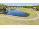 The golf course is set against a beautiful lake and homes in the distance at 1084 Berkshire Ln, Tarpon Springs, FL 34688