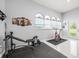 Dedicated home gym space featuring exercise equipment, large windows for natural light, and wall art for motivation at 1084 Berkshire Ln, Tarpon Springs, FL 34688