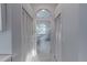 Hallway leading to a bathroom with a standalone tub and bright natural light at 1084 Berkshire Ln, Tarpon Springs, FL 34688