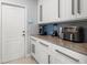 Kitchen area with white cabinets and marble countertops at 1084 Berkshire Ln, Tarpon Springs, FL 34688