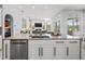 Expansive kitchen with central island, stainless steel appliances, and seamless flow into the living area at 1084 Berkshire Ln, Tarpon Springs, FL 34688