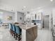Open kitchen boasts a large marble island with seating and white cabinetry, perfect for entertaining at 1084 Berkshire Ln, Tarpon Springs, FL 34688