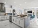 Open-concept kitchen with island, stainless appliances, and view of the living area at 1084 Berkshire Ln, Tarpon Springs, FL 34688