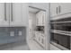 Kitchen has stainless double ovens and a butler's pantry with white cabinets at 1084 Berkshire Ln, Tarpon Springs, FL 34688