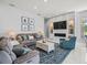 Spacious living room with fireplace, television, and stylish furniture at 1084 Berkshire Ln, Tarpon Springs, FL 34688