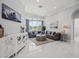 Elegant living room with marble floors, plush seating, and views of the screened lanai at 1084 Berkshire Ln, Tarpon Springs, FL 34688