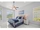Bedroom with ceiling fan, windows, and sliding glass doors at 1084 Berkshire Ln, Tarpon Springs, FL 34688