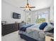 Bedroom with ceiling fan, dresser, and windows at 1084 Berkshire Ln, Tarpon Springs, FL 34688