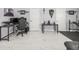 Well-organized office and workout space with multiple desks, minimalist decor, and workout bench with weights at 1084 Berkshire Ln, Tarpon Springs, FL 34688