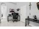 Well-lit office space with a modern desk setup, gaming display, and minimalist decor for enhanced productivity at 1084 Berkshire Ln, Tarpon Springs, FL 34688