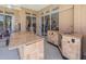 Outdoor kitchen, complete with bar, tiled floors, screened in porch and views of the interior and pool at 1084 Berkshire Ln, Tarpon Springs, FL 34688