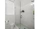 Modern shower stall featuring marble tiles, glass door, and a rain shower head at 1084 Berkshire Ln, Tarpon Springs, FL 34688