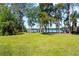Backyard featuring lake access and well maintained lawn and landscaping at 18906 Crescent Rd, Odessa, FL 33556