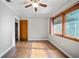Cozy bedroom with vinyl flooring, natural light, and an open doorway at 18906 Crescent Rd, Odessa, FL 33556
