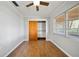 Neat bedroom featuring laminate floors, neutral walls, and a ceiling fan at 18906 Crescent Rd, Odessa, FL 33556