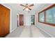 Spacious bedroom with large closet, neutral gray walls, and two windows at 18906 Crescent Rd, Odessa, FL 33556