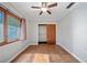 Comfortable bedroom with hardwood flooring, a ceiling fan, and an open closet at 18906 Crescent Rd, Odessa, FL 33556