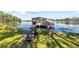 Rustic wooden dock extending into a serene lake, offering a tranquil waterfront experience at 18906 Crescent Rd, Odessa, FL 33556