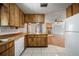View from kitchen to living room with stone fireplace, tile floors and wood cabinets at 18906 Crescent Rd, Odessa, FL 33556