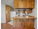 Kitchen with wood cabinets and breakfast bar, white appliances and tile floors at 18906 Crescent Rd, Odessa, FL 33556