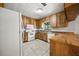 Bright kitchen with white tile floors, wood cabinets and white appliances at 18906 Crescent Rd, Odessa, FL 33556