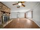 Open living room features a stone fireplace, wood-look floors, and natural light at 18906 Crescent Rd, Odessa, FL 33556