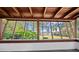 Covered patio featuring natural wood beams and white brick with views of the lake at 18906 Crescent Rd, Odessa, FL 33556