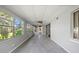 Bright sunroom featuring tile floors, neutral paint, ceiling fan and multiple windows offering natural light and views at 18906 Crescent Rd, Odessa, FL 33556
