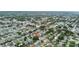 This aerial view shows the home's proximity to a picturesque lake and neighborhood amenities at 2166 Dixie Garden Loop, Holiday, FL 34690