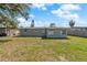 The backyard has mature trees and a grassy area offering a serene outdoor space at 2166 Dixie Garden Loop, Holiday, FL 34690