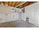 Unfinished basement with concrete floor, water heater, and exposed ceiling at 2166 Dixie Garden Loop, Holiday, FL 34690