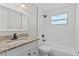 Updated bathroom features subway tile shower, granite countertop, and modern fixtures at 2166 Dixie Garden Loop, Holiday, FL 34690