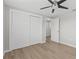 Bedroom features wood-look flooring, large closet, and access to other rooms at 2166 Dixie Garden Loop, Holiday, FL 34690