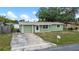 Charming single-Gathering home featuring a well-maintained lawn, attached garage, and inviting curb appeal in a desirable neighborhood at 2166 Dixie Garden Loop, Holiday, FL 34690