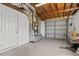 Spacious garage features concrete flooring, overhead door, and utility connections at 2166 Dixie Garden Loop, Holiday, FL 34690