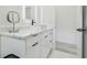 Bright bathroom features a modern vanity with stylish fixtures, white cabinetry, and elegant marble countertops at 2305 W Kentucky Ave, Tampa, FL 33607