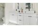 Bright bathroom featuring dual sinks, modern fixtures, and elegant white cabinetry at 2305 W Kentucky Ave, Tampa, FL 33607