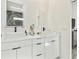 Bright bathroom featuring dual sinks, modern fixtures, and elegant white cabinetry at 2305 W Kentucky Ave, Tampa, FL 33607