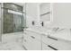 Modern bathroom showcases marble countertops, a sleek vanity, and a glass-enclosed shower with tile surround at 2305 W Kentucky Ave, Tampa, FL 33607