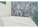 Modern white bathtub with blue marble-style tile accent wall at 2305 W Kentucky Ave, Tampa, FL 33607