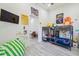 Playful bedroom featuring twin bunk beds, bright decor, and gray flooring at 2305 W Kentucky Ave, Tampa, FL 33607