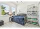 Cozy bedroom with two large windows and a white display shelf filled with toys at 2305 W Kentucky Ave, Tampa, FL 33607