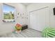 Sunny bedroom with gray flooring, whimsical decor, and a spacious closet at 2305 W Kentucky Ave, Tampa, FL 33607