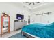 Modern bedroom featuring a TV, grey dresser, orange cabinet, and stylish sliding barn door at 2305 W Kentucky Ave, Tampa, FL 33607