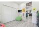 Bedroom with a spacious closet, fun wall decor, and an adjacent living space at 2305 W Kentucky Ave, Tampa, FL 33607
