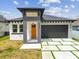Charming single-story home featuring a modern architectural design and well-manicured lawn at 2305 W Kentucky Ave, Tampa, FL 33607