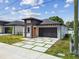 New construction home featuring a modern design, neutral paint, and a two-car garage at 2305 W Kentucky Ave, Tampa, FL 33607