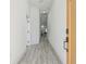 Bright hallway with modern lighting and light grey wood-look flooring at 2305 W Kentucky Ave, Tampa, FL 33607