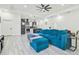 Bright, open-concept living space with modern gray floors and a comfortable, blue sectional sofa at 2305 W Kentucky Ave, Tampa, FL 33607