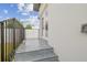 Outdoor patio featuring gray tiling, a metal railing, and a private entrance at 2305 W Kentucky Ave, Tampa, FL 33607